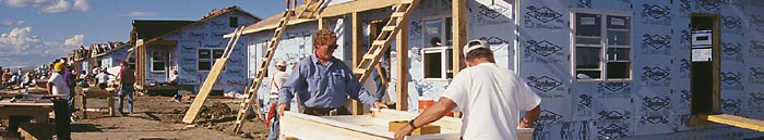 Photo of people building a house.